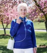 The Inogen G4 portable oxygen concentrator  woman user outdoors.